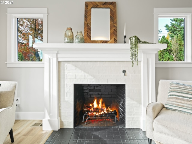 room details featuring hardwood / wood-style flooring and a brick fireplace