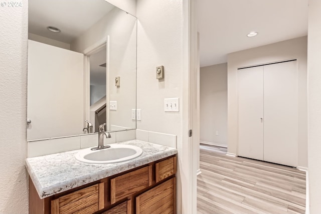 bathroom with wood finished floors and vanity