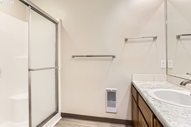 full bath featuring a stall shower, visible vents, vanity, and wood finished floors