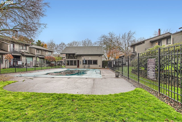 pool featuring fence, a lawn, and a patio