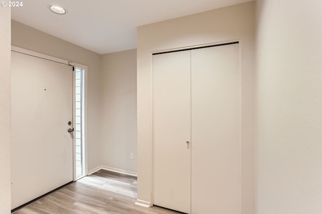 entryway with light wood-type flooring and baseboards