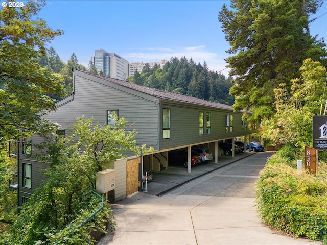 view of side of home with a carport