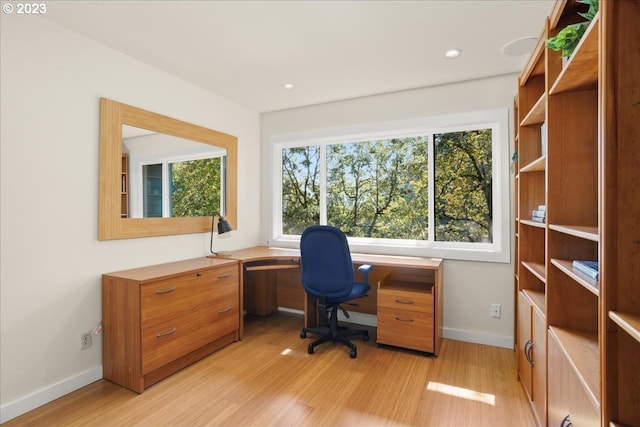 home office featuring a healthy amount of sunlight and light wood-type flooring