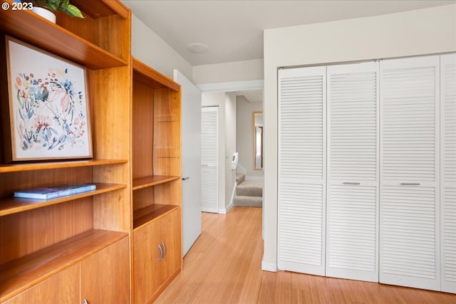 corridor with light hardwood / wood-style floors