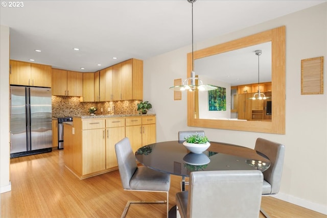 dining room with a chandelier and light hardwood / wood-style flooring