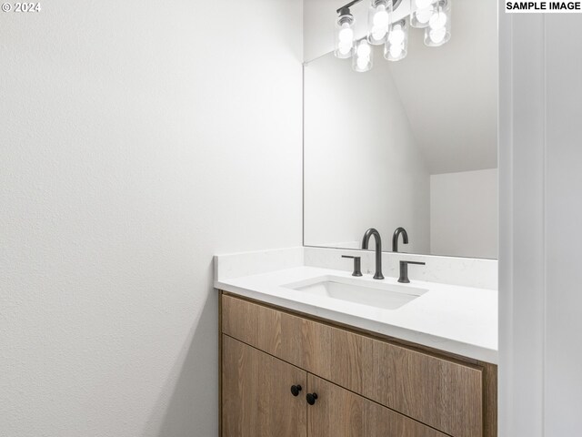 7467 N New York Ave Unit 5, Portland, OR 97203 - bathroom with vaulted ceiling and vanity