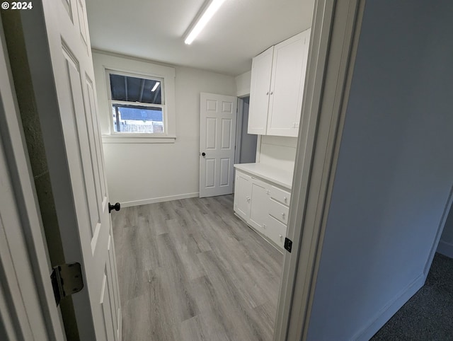 laundry area with light hardwood / wood-style flooring