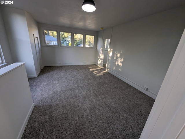 empty room with dark colored carpet