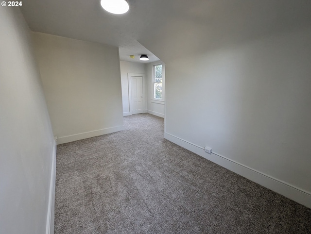 spare room featuring light colored carpet