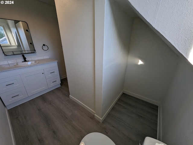 bathroom featuring wood-type flooring, vanity, and toilet