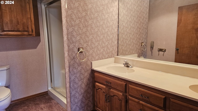 bathroom featuring an enclosed shower, vanity, and toilet