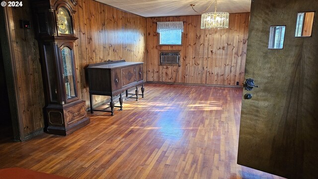 1176 SE 4th Ave, Mill City, OR 97360 - interior space with wood finished floors, wood walls, a chandelier, and a wall mounted air conditioner