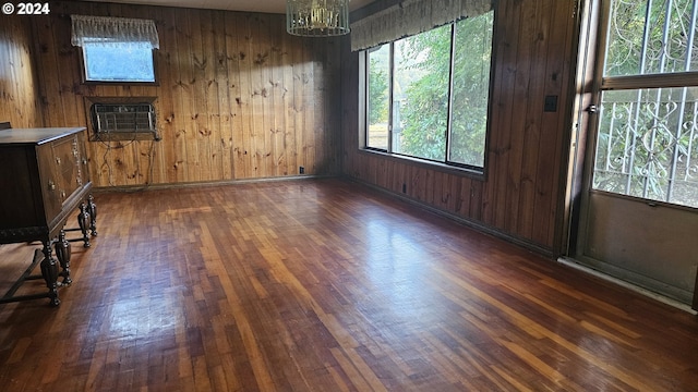 1176 SE 4th Ave, Mill City, OR 97360 - unfurnished dining area with dark wood finished floors, an AC wall unit, wood walls, and a chandelier