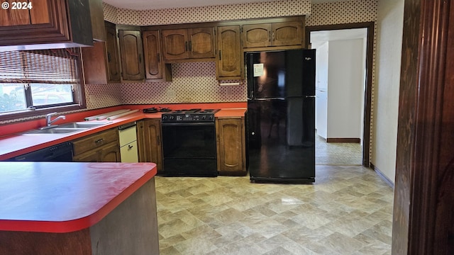 kitchen featuring black appliances, decorative backsplash, and sink