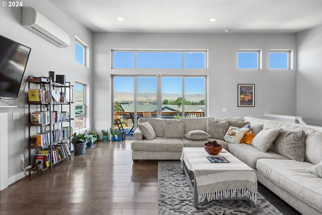 living room featuring dark hardwood / wood-style flooring and an AC wall unit