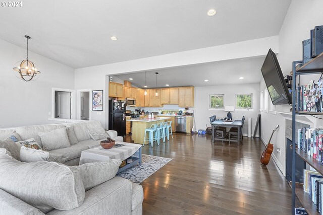 living room featuring dark wood-type flooring and an inviting chandelier