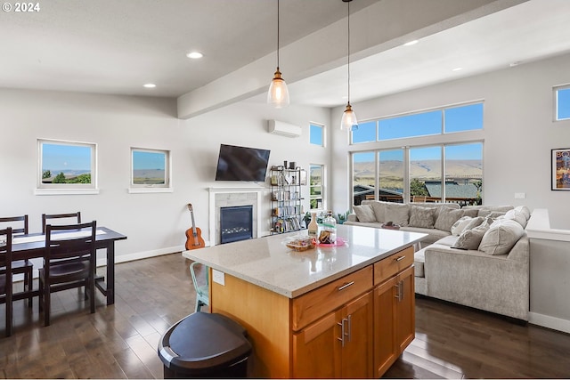 kitchen with beam ceiling, dark hardwood / wood-style flooring, a healthy amount of sunlight, and light stone countertops