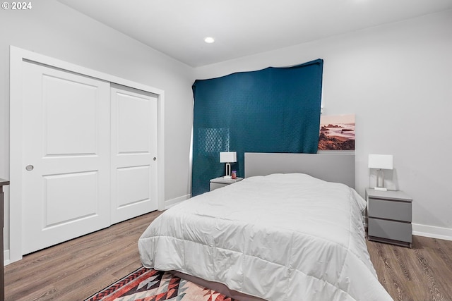 bedroom featuring hardwood / wood-style floors and a closet