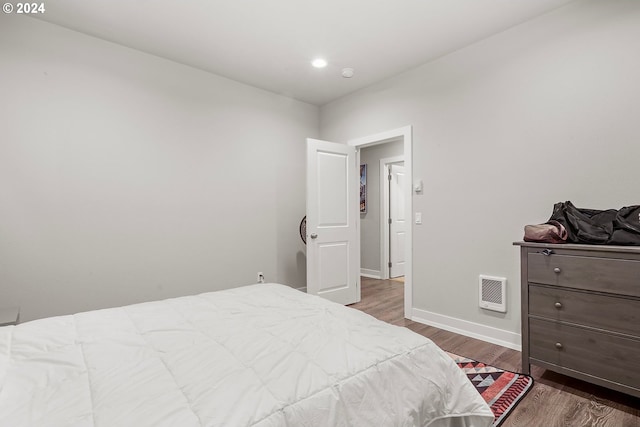 bedroom with hardwood / wood-style flooring