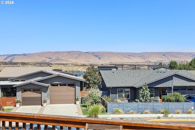 view of front of property with a garage and a mountain view