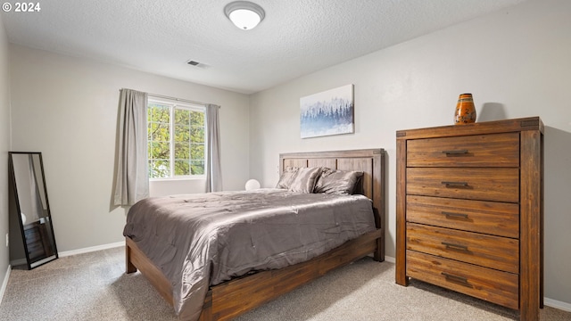 carpeted bedroom with a textured ceiling