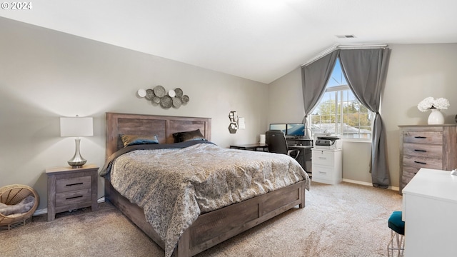 bedroom featuring light carpet and vaulted ceiling