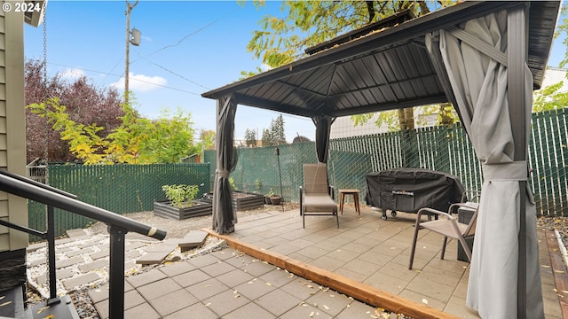 view of patio with a gazebo and a grill