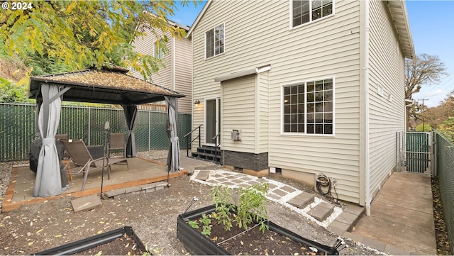 rear view of property with a gazebo