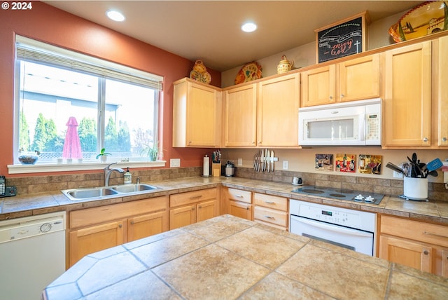 kitchen with light brown cabinets, tile counters, sink, and white appliances