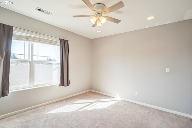 carpeted spare room with ceiling fan