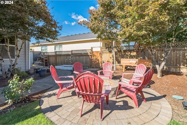 view of patio / terrace featuring a fire pit and a jacuzzi