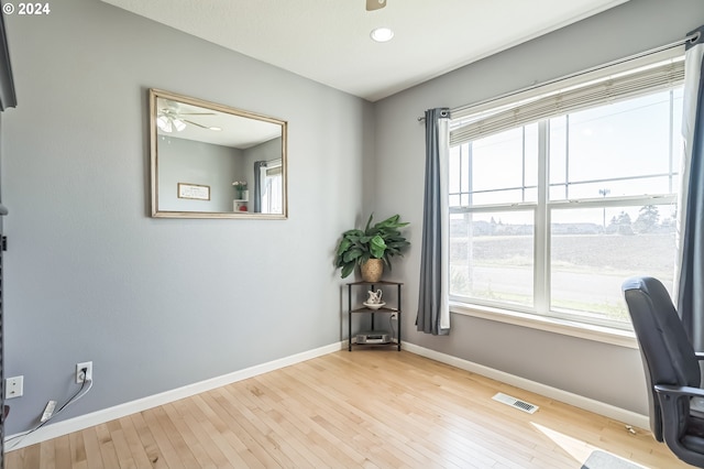 office featuring light hardwood / wood-style floors and ceiling fan