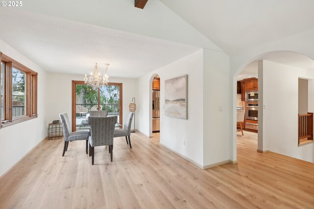 kitchen featuring light carpet, hanging light fixtures, a textured ceiling, beverage cooler, and backsplash