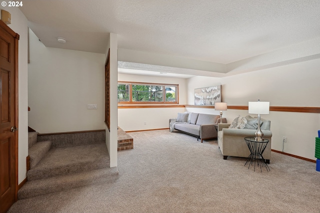 carpeted living room featuring a textured ceiling