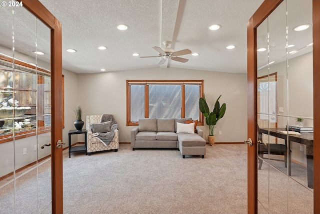 living room featuring carpet floors, vaulted ceiling, french doors, and a textured ceiling