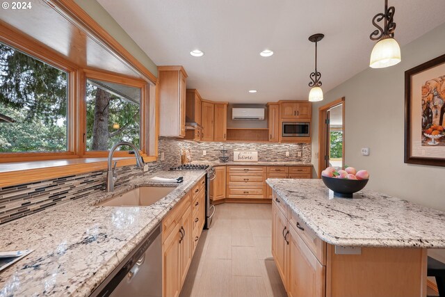 kitchen with sink, appliances with stainless steel finishes, backsplash, a kitchen island, and an AC wall unit