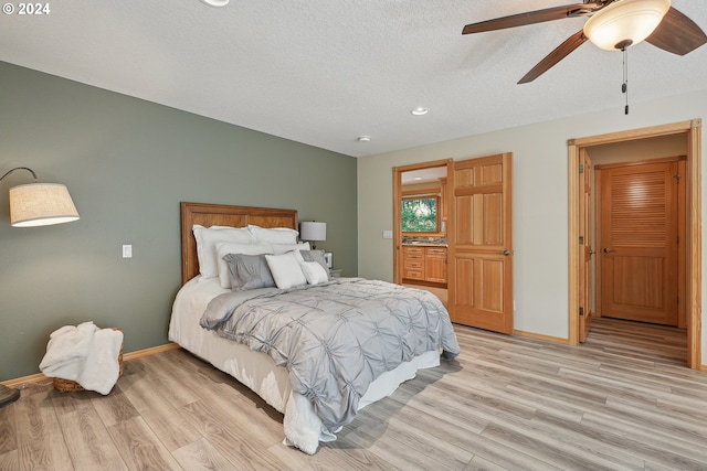 bedroom with ceiling fan and light wood-type flooring