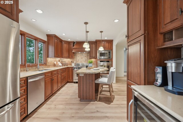 4243 Spring Rock Cir, West Linn, OR 97068 - kitchen featuring stainless steel appliances, a kitchen bar, custom range hood, light wood finished floors, and light countertops