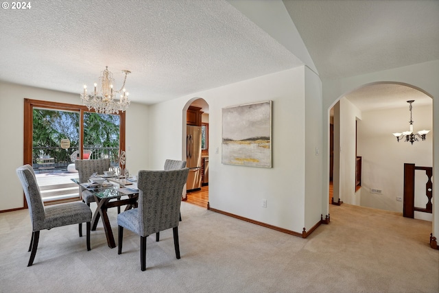 carpeted dining space featuring a chandelier