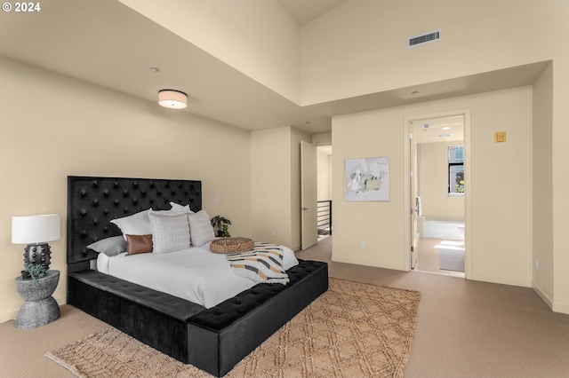 bedroom featuring a towering ceiling, carpet flooring, visible vents, and baseboards