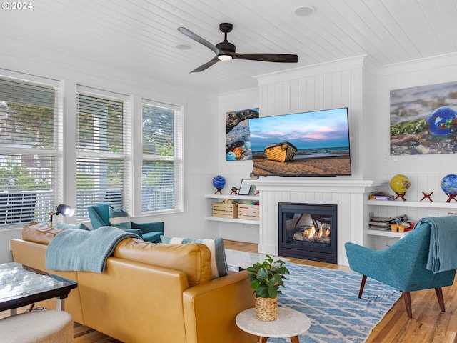 living room with wood ceiling, ceiling fan, wood-type flooring, and ornamental molding