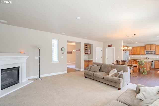 living room with light carpet and a chandelier