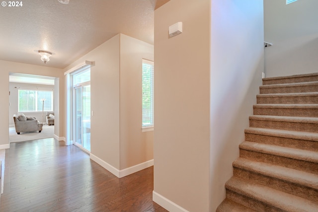 15003 NE 102nd St, Vancouver, WA 98682 - stairs featuring baseboards, a textured ceiling, and wood finished floors