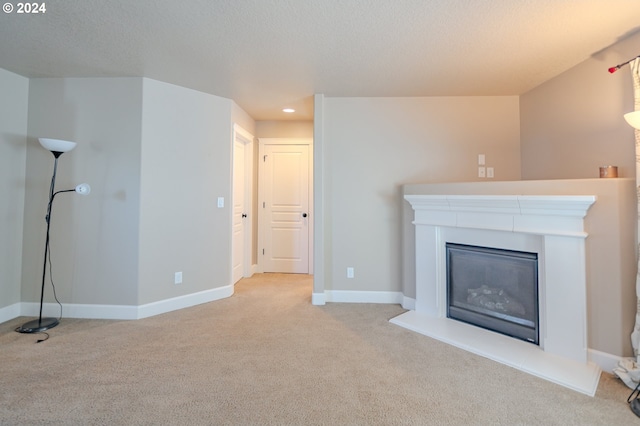 unfurnished living room featuring light carpet