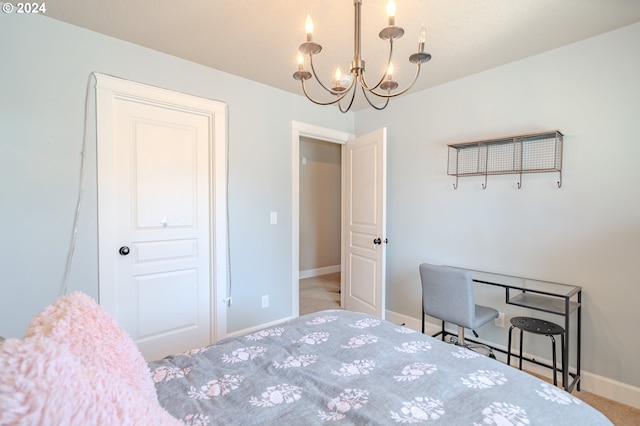 carpeted bedroom featuring a notable chandelier