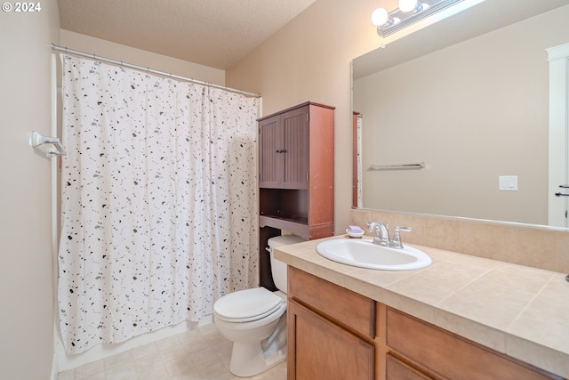 bathroom with toilet, a textured ceiling, and vanity