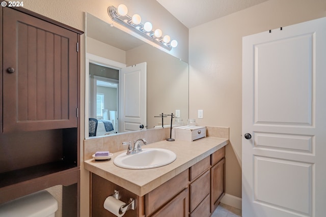 bathroom featuring tile patterned flooring and vanity