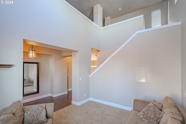 carpeted living room with a high ceiling