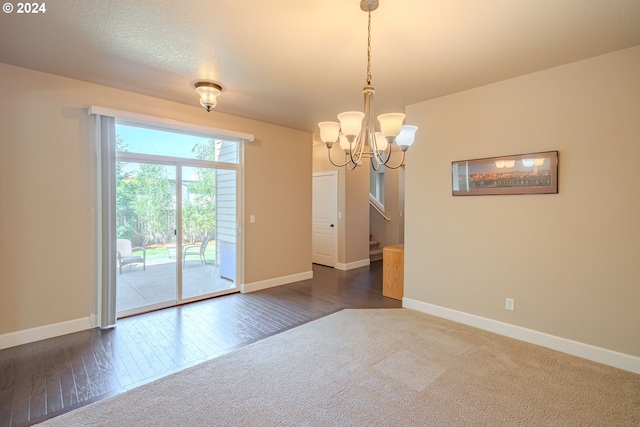 15003 NE 102nd St, Vancouver, WA 98682 - unfurnished room with baseboards, a chandelier, dark carpet, and dark wood-type flooring