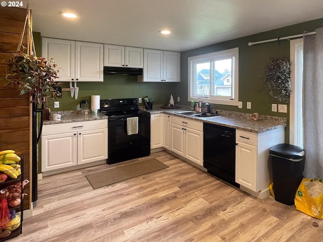 kitchen with black appliances, light hardwood / wood-style floors, white cabinets, and sink